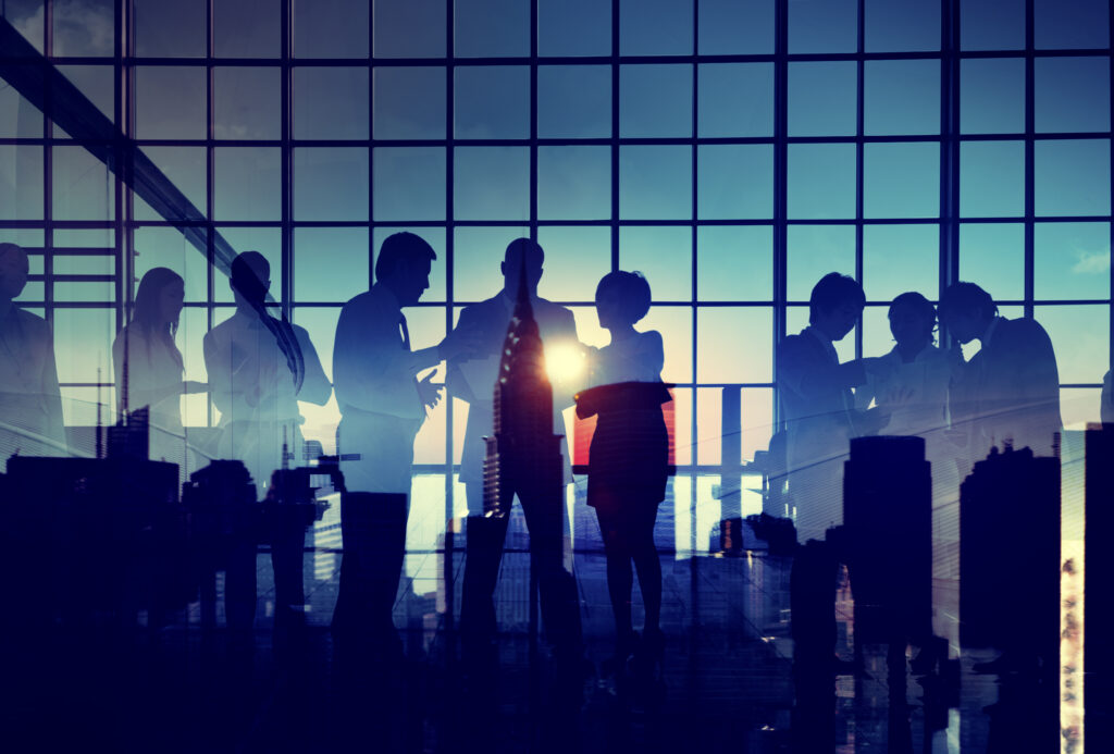 Group of business people brainstorming with silhouette sunset